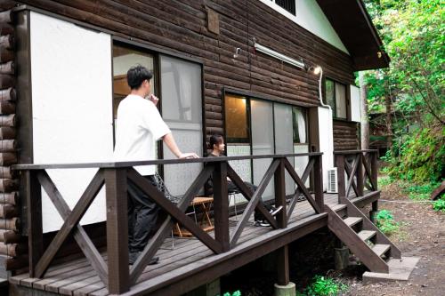 a man and a woman standing on a deck of a house at Sunland S45 - Vacation STAY 45835v in Saikubo