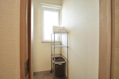 a room with a towel rack next to a window at Condominium Hanazono - Vacation STAY 14690 in Biei
