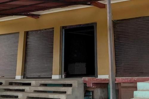 a house with two windows with blinds on it at SPOT ON The Cocoon Palace in Sarāi Ajitmal