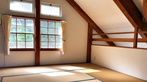 an empty room with windows in a attic at Tabino Camping Base Kami Yuland - Vacation STAY 52574v in Osaki
