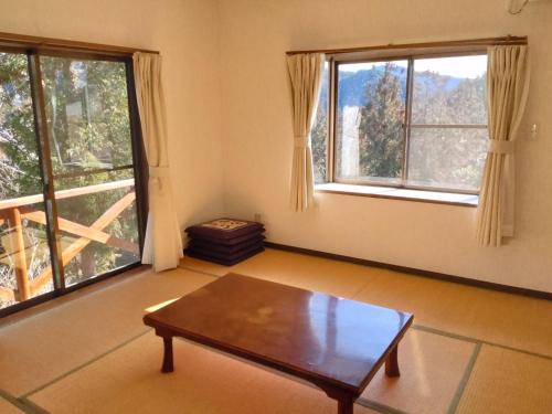 a living room with a table and two windows at Tenten Go Shibukawa - Vacation STAY 41129v in Ono