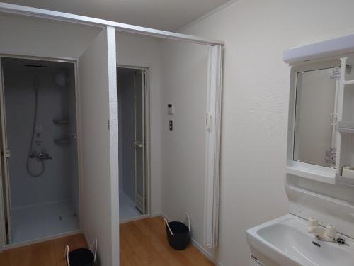 a white bathroom with a shower and a sink at Kinoene SAKE CAMP - Camp - Vacation STAY 42047v in Shisui