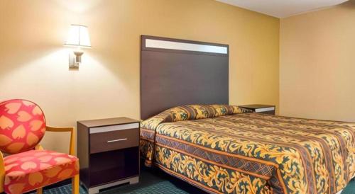 a hotel room with a bed and a chair at Rodeway Inn Mount Laurel Hwy 73 in Mount Laurel