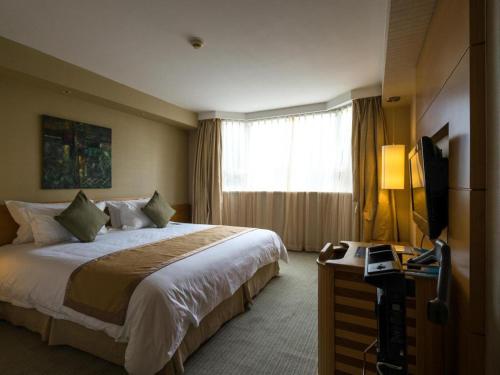 En eller flere senge i et værelse på Jinglun Hotel