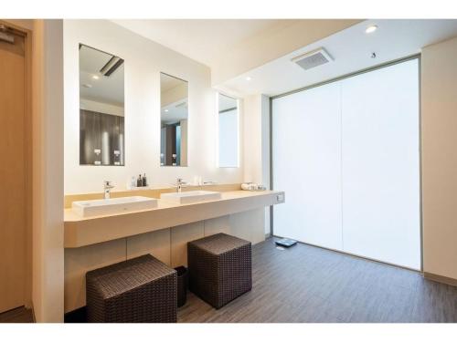 a bathroom with two sinks and two mirrors at Atami Spa & Resort - Vacation STAY 14644 in Atami