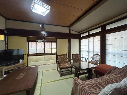 a living room with a couch and a tv at Hakuigun - House - Vacation STAY 14651 in Akasaki