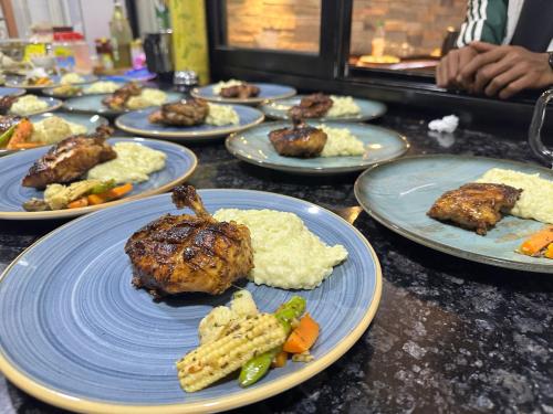 a table full of plates of food with meat and vegetables at Lumbini Five Elements Hotel in Lumbini