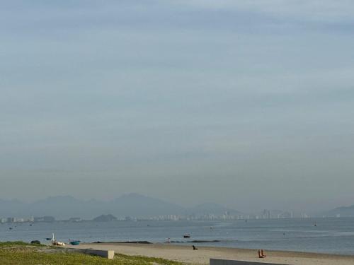 a view of a beach with a city in the distance at Palm Riverside Boutique in Hoi An