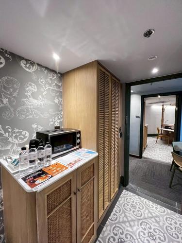a kitchen with a counter with a microwave at The Quarter Chaophraya by UHG in Bangkok