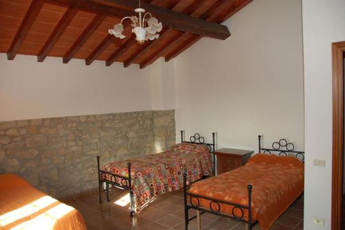 Postel nebo postele na pokoji v ubytování Agriturismo Casapasserini