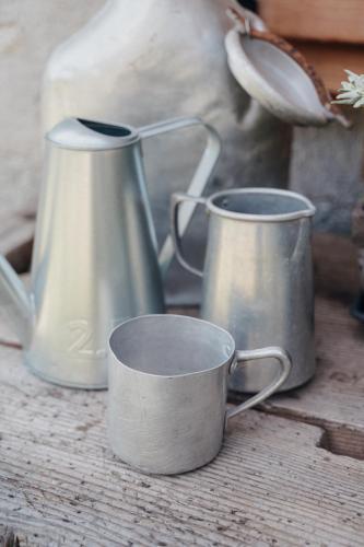 two metal cups sitting on top of a table at Pimont Alpine Chalet in Madonna di Campiglio