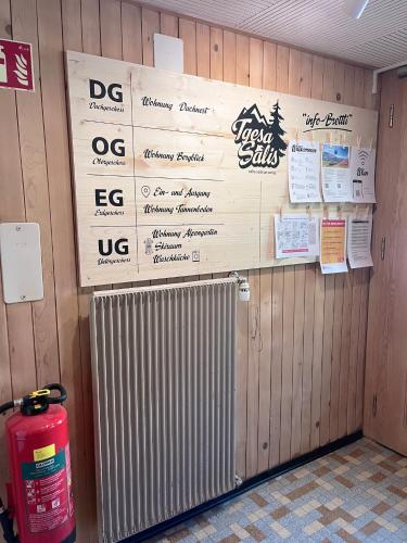 a room with a radiator and signs on a wall at Ferienwohnung Alpengarten in Sedrun
