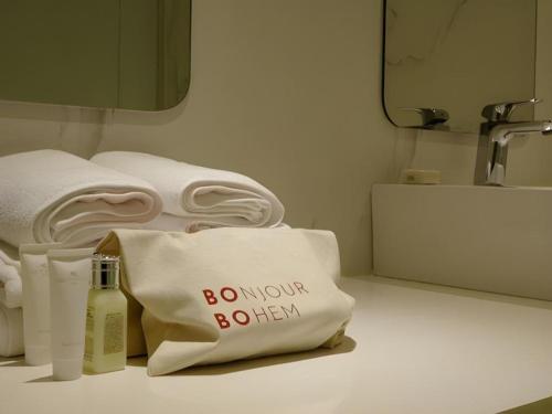 a bathroom with towels and a pillow with the words do not bother at Bobo Hotel Hongdae in Seoul