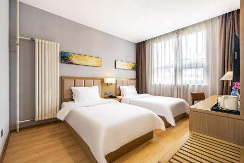 Postel nebo postele na pokoji v ubytování Subaiyun Hotel, Beijing Qianmen Branch