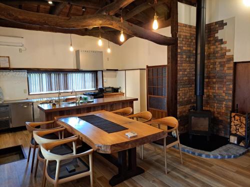a large kitchen with a wooden table and chairs at Former Residence Vacation Rental Minamijuan - Vacation STAY 57751v in Tateyama