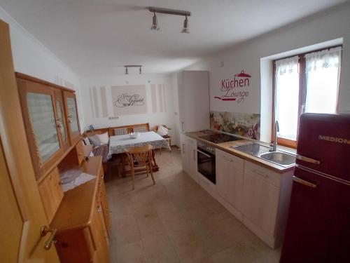 a kitchen with a sink and a stove top oven at Bayerwald Auszeit in Waldkirchen