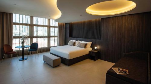 a bedroom with a bed and a large window at Gold Tower Lifestyle Hotel in Naples