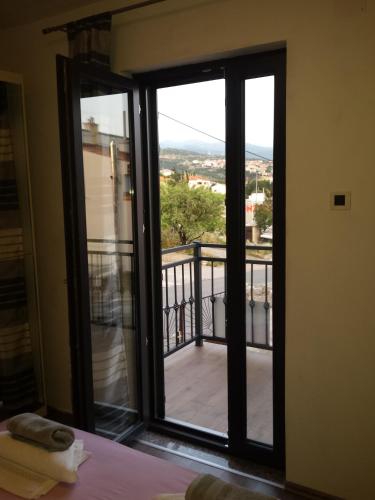 a room with a door open to a balcony at Guest House Sombrero in Senj