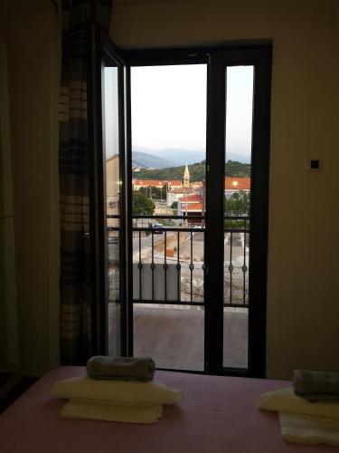 a room with a bed and a window with a view at Guest House Sombrero in Senj
