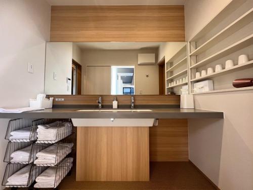 a bathroom with a sink and a counter with towels at SETO CLAS AJI - Vacation STAY 60996v in Sanuki