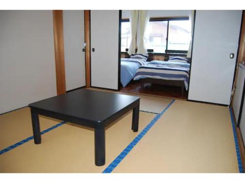 a black table in a room with a bedroom at Minpaku Yagi - Vacation STAY 14700 in Ise