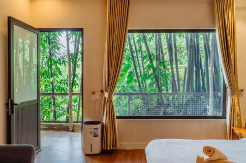 a bedroom with a bed and a large window at Love House Homestay SAPA in Sa Pa