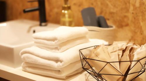 a pile of towels sitting on a bathroom sink at amazing view room 2 - Vacation STAY 66244v in Kushima