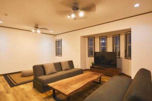 a living room with a couch and a tv at Ocean Resort Tateyama A House - Vacation STAY 73416v in Tateyama