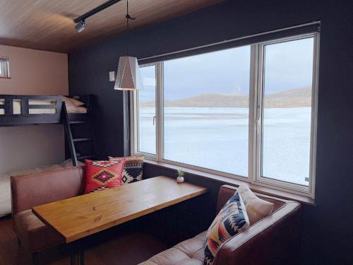 a living room with a table and a couch and a window at FLEXWORK tawa - Vacation STAY 99885v in Teshikaga