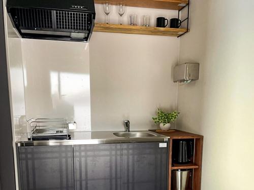 a small kitchen with a sink and a microwave at FLEXWORK tawa - Vacation STAY 75820v in Teshikaga