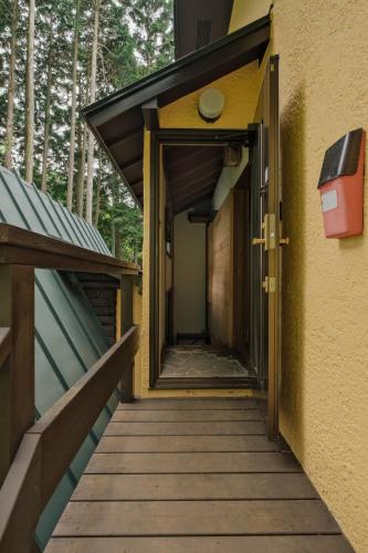 a hallway of a building with an open door at Minami Hakone Tree House - Vacation STAY 14735 in Kannami
