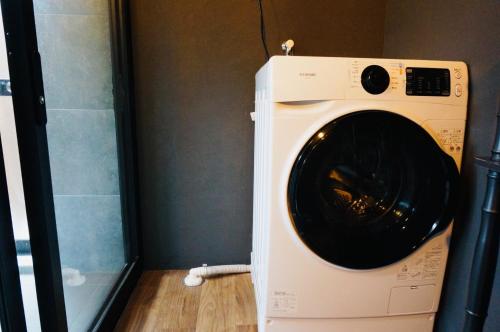 a washing machine in a room with a shower at Takabayashi Shoten Liquor store where you can stay - Vacation STAY 69075v in Oshima