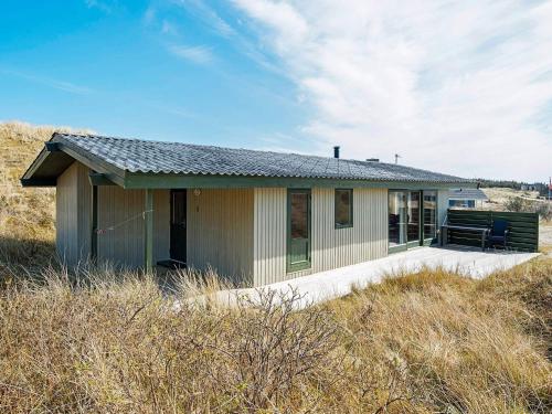 a small house in the middle of a field at 5 person holiday home in Ringkøbing in Søndervig