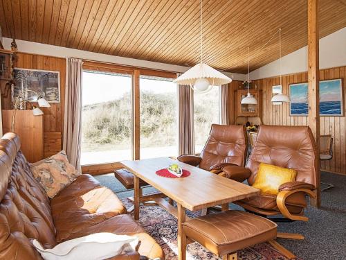 a living room with a couch and a table at 5 person holiday home in Ringkøbing in Søndervig