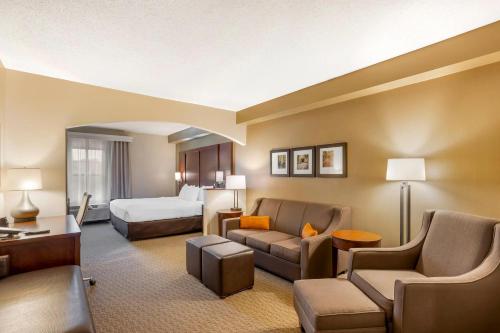 a hotel room with a bed and a living room at Comfort Suites near Penn State - State College, PA in State College