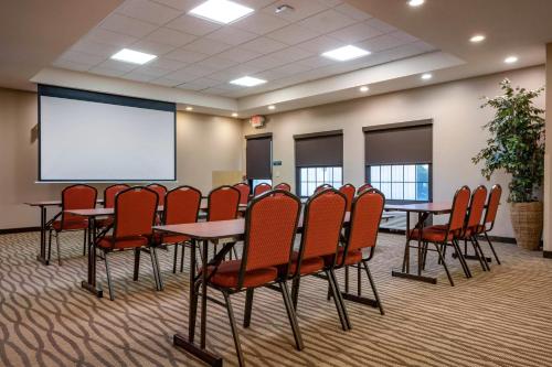 a conference room with tables and chairs and a white screen at Comfort Suites near Penn State - State College, PA in State College