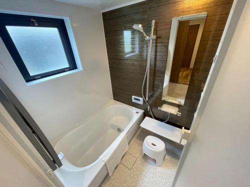 a bathroom with a bath tub and a toilet at Oyado Karasakiya - Vacation STAY 02892v in Tamba-sasayama