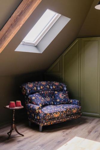 a bed in a room with a skylight at La Maison d’Hôtes in Silly