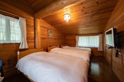 Ένα ή περισσότερα κρεβάτια σε δωμάτιο στο Log house Grazzi - Vacation STAY 70263v