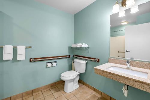 a bathroom with a toilet and a sink at Econo Lodge Inn & Suites in Eau Claire