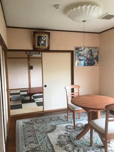 a room with a table and chairs and a dining room at Marine View Shimane - Vacation STAY 78823v in Matsue