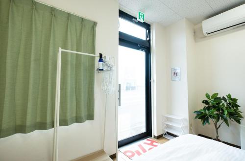 a bedroom with a bed and a window at Ezo Fujiya Niseko House - Vacation STAY 14768 in Kutchan