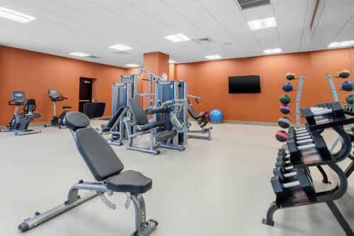 a gym with several treadmills and cardio machines at Cambria Hotel College Park in College Park