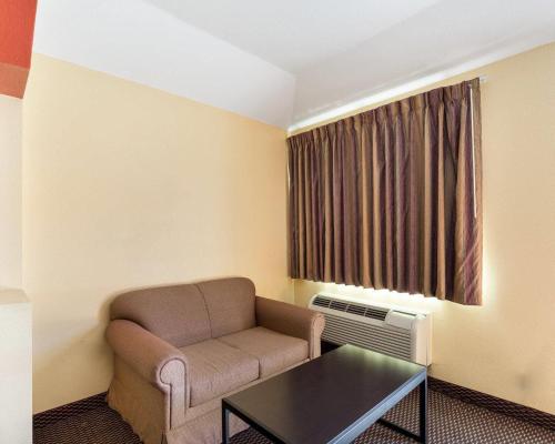 a living room with a couch and a table at Rodeway Inn & Suites in Humble