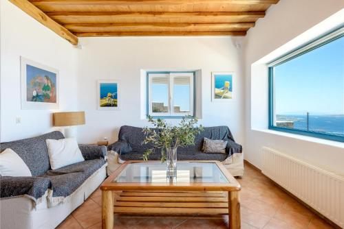 a living room with two couches and a table at Sunset Villa in Houlakia
