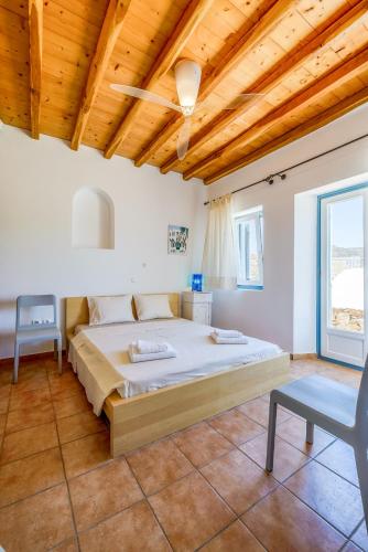 a bedroom with a bed and a wooden ceiling at Sunset Villa in Houlakia