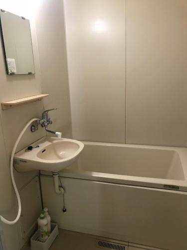 a bathroom with a sink and a bath tub at Marine View Shimane - Vacation STAY 85912v in Matsue