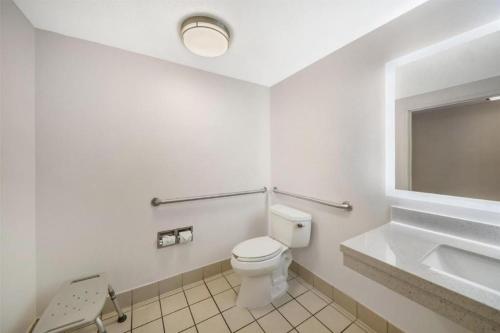 a bathroom with a toilet and a sink and a mirror at Best Western Plus Twin View Inn and Suites in Redding