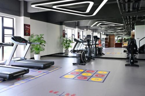 a gym with treadmills and elliptical machines at Shanghai Dixuan Junlan Resort Hotel in Shanghai