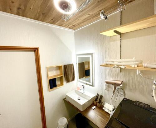 a bathroom with a sink and a mirror at Guest house HaDuNo - Vacation STAY 85297v in Shingu